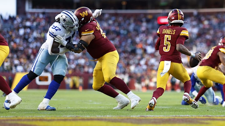 Nov 24, 2024; Landover, Maryland, USA; Washington Commanders quarterback Jayden Daniels (5) scrambles from Dallas Cowboys defensive tackle Osa Odighizuwa (97) during the fourth quarter at Northwest Stadium. Mandatory Credit: Geoff Burke-Imagn Images Nov 24, 2024; Landover, Maryland, USA; Washington Commanders quarterback Jayden Daniels (5) scrambles from Dallas Cowboys defensive tackle Osa Odighizuwa (97) during the fourth quarter at Northwest Stadium. Mandatory Credit: Geoff Burke-Imagn Images