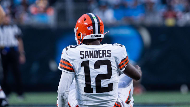 Aug 8, 2025; Charlotte, North Carolina, USA;  Cleveland Browns quarterback Shedeur Sanders (12) gets up slow during the second quarter against the Carolina Panthers at Bank of America Stadium. Mandatory Credit: Scott Kinser-The USAToday Network via Imagn Images 