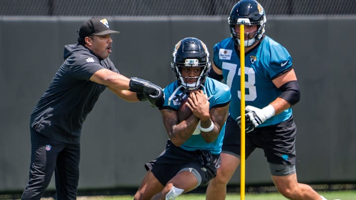 Jacksonville Jaguars wide receiver Dyami Brown (5) runs drill while being pursued by Jacksonville Jaguars center Robert Hainsey (73) during the fourth organized team activity at the Miller Electric Center in Jacksonville, Fla. Tuesday, May 27, 2025. [Doug Engle/Florida Times-Union]