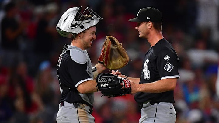Chicago White Sox catcher Kyle Teel (8) and pitcher Jordan Leasure (49) celebrate the victory against the Los Angeles Angels at Angel Stadium. 