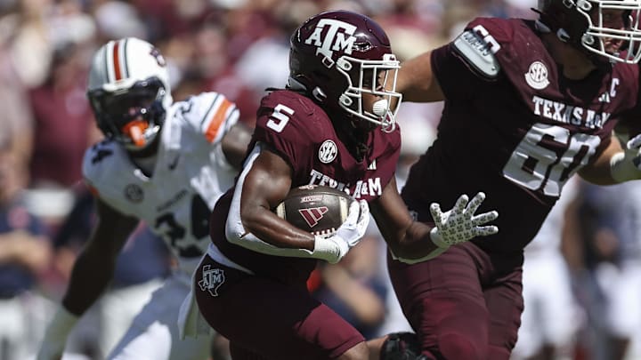 Sep 27, 2025; College Station, Texas, USA; Texas A&M Aggies running back Amari Daniels (5) runs with the ball during the first quarter against the Auburn Tigers at Kyle Field. Mandatory Credit: Troy Taormina-Imagn Images
