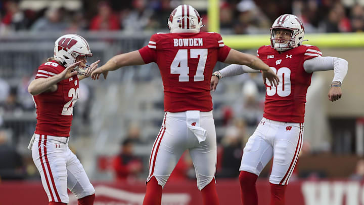 Wisconsin Badgers punter Gavin Meyers (28), long snapper Peter Bowden (47) and place kicker Nathanial Vakos (90) celebrate after a field goal by Vakos against the Iowa Hawkeyes at Camp Randall Stadium. 
