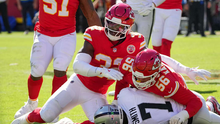 Oct 19, 2025; Kansas City, Missouri, USA; Kansas City Chiefs defensive end George Karlaftis (56) and linebacker Nick Bolton (32) tackle Las Vegas Raiders quarterback Geno Smith (7) during the second quarter of the game at GEHA Field at Arrowhead Stadium. Mandatory Credit: Denny Medley-Imagn Images