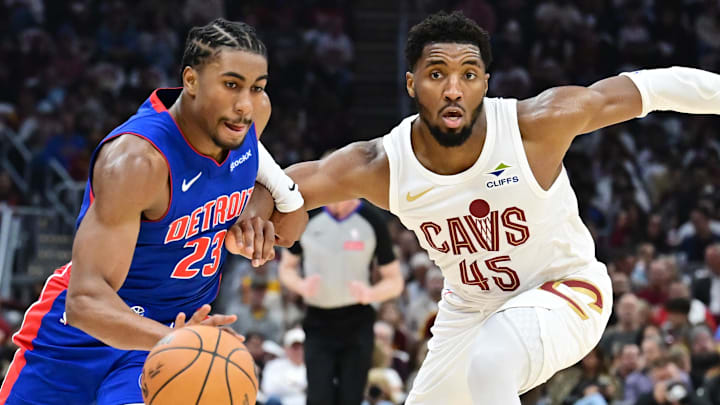 Oct 25, 2024; Cleveland, Ohio, USA; Detroit Pistons guard Jaden Ivey (23) drives to the basket against Cleveland Cavaliers guard Donovan Mitchell (45) during the first half at Rocket Mortgage FieldHouse. Mandatory Credit: Ken Blaze-Imagn Images