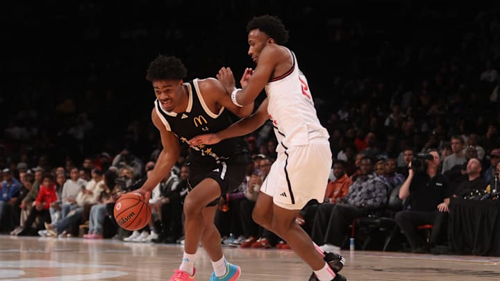 Apr 1, 2025; Brooklyn, NY, USA; McDonald's All American East forward Jalen Haralson (4) dribbles the ball against McDonald's All American West guard Darryn Peterson (22) during the second half of the game at Barclays Center. Mandatory Credit: Pamela Smith-Imagn Images
