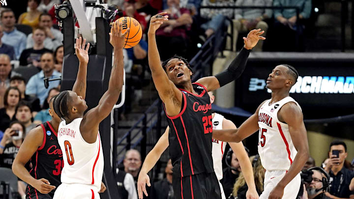 Mar 24, 2022; San Antonio, TX, USA; Arizona Wildcats guard Bennedict Mathurin (0) and Houston Cougars center Josh Carlton (25) go for the ball during the second half in the semifinals of the South regional of the men's college basketball NCAA Tournament at AT&T Center. Mandatory Credit: Scott Wachter-Imagn Images
