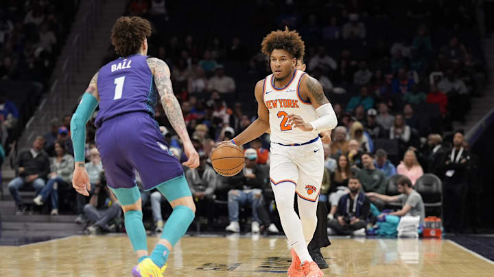 Mar 20, 2025; Charlotte, North Carolina, USA; New York Knicks guard Miles McBride (2) brings the ball up court against Charlotte Hornets guard LaMelo Ball (1)  during the first quarter at Spectrum Center. Mandatory Credit: Jim Dedmon-Imagn Images