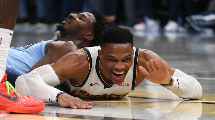Nov 19, 2024; Memphis, Tennessee, USA; Denver Nuggets guard Russell Westbrook (4) reacts as he lays on the court during the second half against the Memphis Grizzlies at FedExForum. Mandatory Credit: Petre Thomas-Imagn Images
