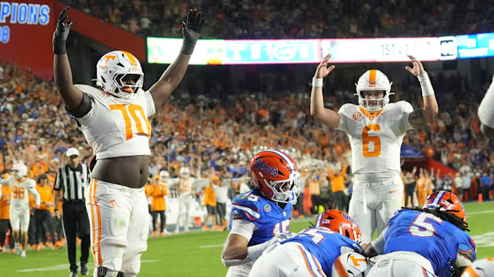 Tennessee offensive lineman David Sanders Jr. (70) and quarterback Joey Aguilar (6) signal a touchdown as Tennessee running back Star Thomas (9) scores a touchdown during an NCAA college football game against Florida on November 22, 2025, in Gainesville, Florida.
