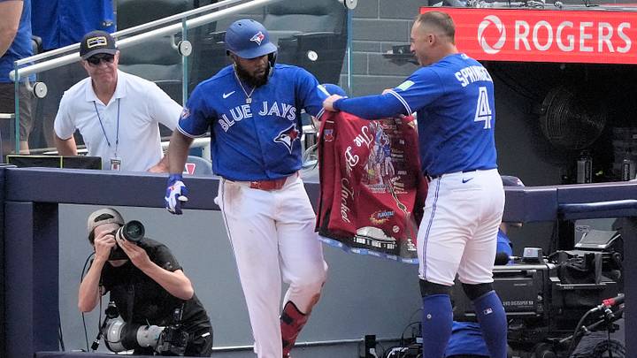Sep 13, 2026; Toronto, Ontario, CAN; Toronto Blue Jays designated hitter George Springer (4) puts the home run jacket onto first baseman Vladimir Guerrero Jr. (27) after his solo home run during the fifth inning against the Baltimore Orioles at Rogers Centre. Mandatory Credit: John E. Sokolowski-Imagn Images Sep 13, 2026; Toronto, Ontario, CAN; Toronto Blue Jays designated hitter George Springer (4) puts the home run jacket onto first baseman Vladimir Guerrero Jr. (27) after his solo home run during the fifth inning against the Baltimore Orioles at Rogers Centre. Mandatory Credit: John E. Sokolowski-Imagn Images
