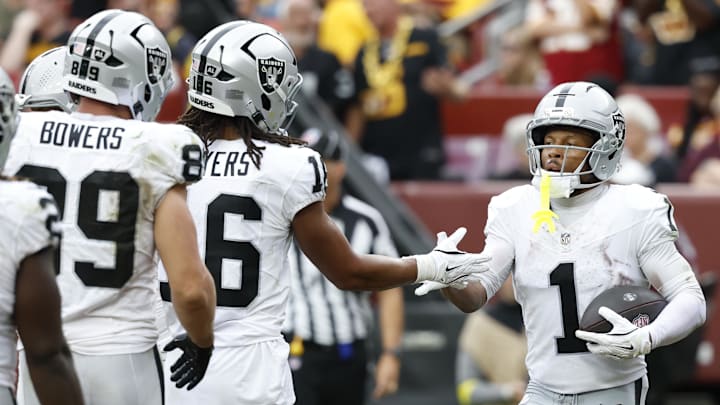 Sep 21, 2025; Landover, Maryland, USA; Las Vegas Raiders wide receiver Tre Tucker (1) celebrates with teammates after scoring a touchdown against the Washington Commanders during the third quarter at Northwest Stadium. Mandatory Credit: Geoff Burke-Imagn Images