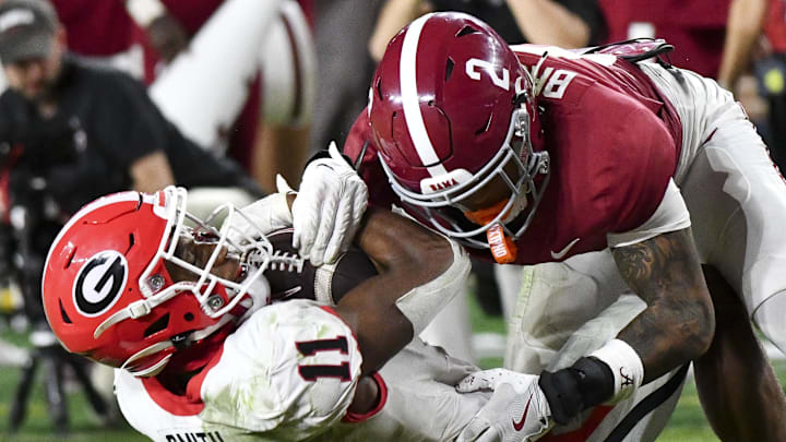 Sep 28, 2024; Tuscaloosa, Alabama, USA; Georgia Bulldogs wide receiver Arian Smith (11) is tackled by Alabama Crimson Tide defensive back Zabien Brown (2) after a long reception to set up a touchdown at Bryant-Denny Stadium. Alabama defeated Georgia 41-34. Mandatory Credit: Gary Cosby Jr.-Imagn Images Sep 28, 2024; Tuscaloosa, Alabama, USA; Georgia Bulldogs wide receiver Arian Smith (11) is tackled by Alabama Crimson Tide defensive back Zabien Brown (2) after a long reception to set up a touchdown at Bryant-Denny Stadium. Alabama defeated Georgia 41-34. Mandatory Credit: Gary Cosby Jr.-Imagn Images