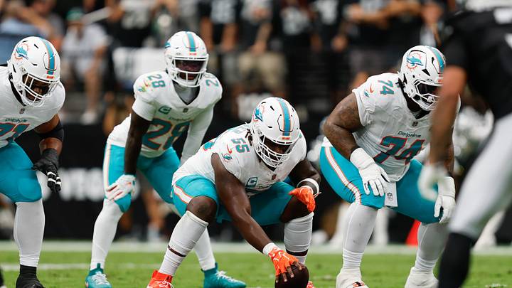 Miami Dolphins center Aaron Brewer (55) prepares to snap the ball against the Las Vegas Raiders at Allegiant Stadium. Miami Dolphins center Aaron Brewer (55) prepares to snap the ball against the Las Vegas Raiders at Allegiant Stadium.