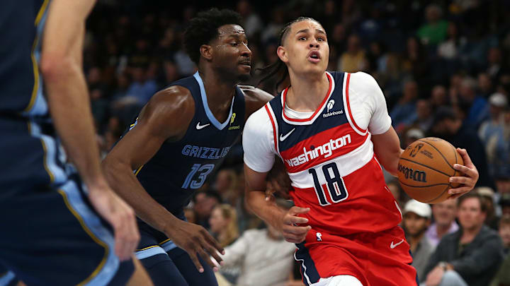 Nov 8, 2024; Memphis, Tennessee, USA; Washington Wizards forward Kyshawn George (18) drives against Memphis Grizzlies forward Jaren Jackson Jr. (13) during the first half at FedExForum. Mandatory Credit: Petre Thomas-Imagn Images