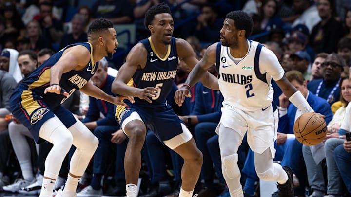 Mar 8, 2023; New Orleans, Louisiana, USA; Dallas Mavericks guard Kyrie Irving (2) dribbles against New Orleans Pelicans forward Herbert Jones (5) and guard CJ McCollum (3) during the second half at Smoothie King Center. Mandatory Credit: Stephen Lew-Imagn Images Mar 8, 2023; New Orleans, Louisiana, USA; Dallas Mavericks guard Kyrie Irving (2) dribbles against New Orleans Pelicans forward Herbert Jones (5) and guard CJ McCollum (3) during the second half at Smoothie King Center. Mandatory Credit: Stephen Lew-Imagn Images