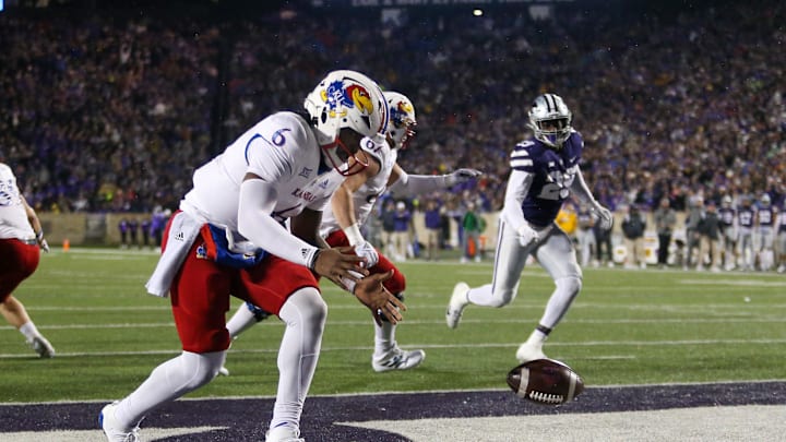 Nov 26, 2022; Manhattan, Kansas, USA; Kansas Jayhawks quarterback Jalon Daniels (6) tries to pick up the ball in his own end zone during the first quarter against the Kansas State Wildcats at Bill Snyder Family Football Stadium. Mandatory Credit: Scott Sewell-Imagn Images Nov 26, 2022; Manhattan, Kansas, USA; Kansas Jayhawks quarterback Jalon Daniels (6) tries to pick up the ball in his own end zone during the first quarter against the Kansas State Wildcats at Bill Snyder Family Football Stadium. Mandatory Credit: Scott Sewell-Imagn Images