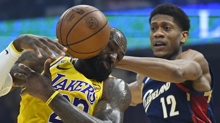Jan 28, 2026; Cleveland, Ohio, USA; Los Angeles Lakers forward LeBron James (23) and Cleveland Cavaliers forward De'Andre Hunter (12) reach for a loose ball in the first quarter at Rocket Arena. Mandatory Credit: David Richard-Imagn Images