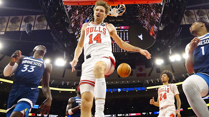 Oct 16, 2025; Chicago, Illinois, USA; Chicago Bulls forward Matas Buzelis (14) scores on Minnesota Timberwolves forward Leonard Miller (33) during the first half at United Center. Mandatory Credit: David Banks-Imagn Images