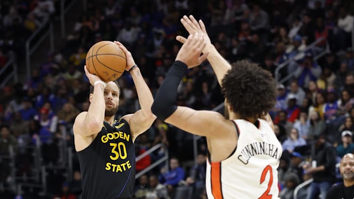 Jan 9, 2025; Detroit, Michigan, USA;  Golden State Warriors guard Stephen Curry (30) shoots against Detroit Pistons guard Cade Cunningham (2) in the second half at Little Caesars Arena. Mandatory Credit: Rick Osentoski-Imagn Images