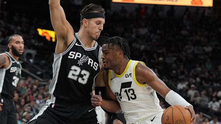 Nov 9, 2024; San Antonio, Texas, USA;  Utah Jazz guard Isaiah Collier (13) drives in against San Antonio Spurs forward Zach Collins (23) in the first half at Frost Bank Center. Mandatory Credit: Daniel Dunn-Imagn Images