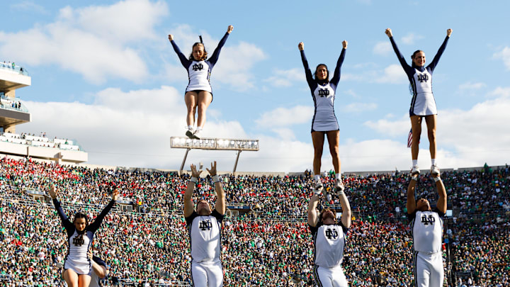 Notre Dame cheerleaders fly through the air in the first half of a NCAA football game against NC State at Notre Dame Stadium on Saturday, Oct. 11, 2025, in South Bend. Notre Dame cheerleaders fly through the air in the first half of a NCAA football game against NC State at Notre Dame Stadium on Saturday, Oct. 11, 2025, in South Bend.