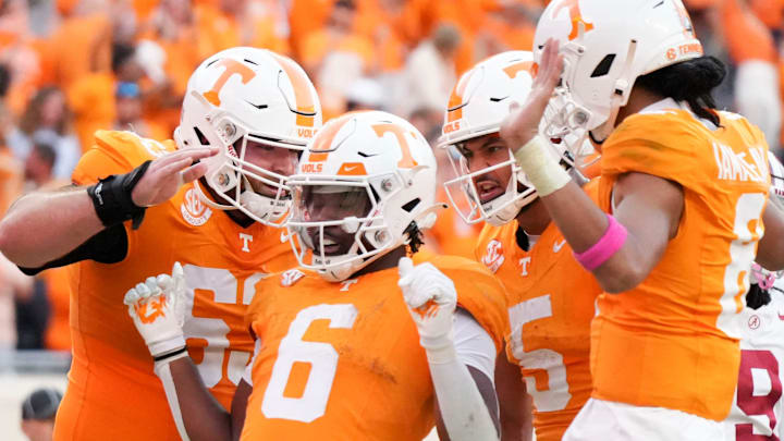 Tennessee offensive lineman Cooper Mays (63), wide receiver Bru McCoy (5), and quarterback Nico Iamaleava (8) surround running back Dylan Sampson (6) in celebration after Sampson's touchdown during an NCAA college football game against Alabama on Saturday, Oct. 19, 2024, in Knoxville. Tenn.
