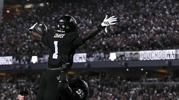Texas A&M Aggies offensive lineman Ar'Maj Reed-Adams (55) hoists  wide receiver Mario Craver (1) in celebrations after he scored touchdown during the fourth quarter against the Mississippi State Bulldogs at Kyle Field. 