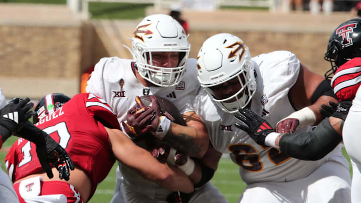Sep 21, 2024; Lubbock, Texas, USA;  Arizona State Sun Devils running back Cam Skattebo (4) rushes against Texas Tech Red Raiders defensive back Jacob Rodriquez (10) in the first half at Jones AT&T Stadium and Cody Campbell Field. Mandatory Credit: Michael C. Johnson-Imagn Images