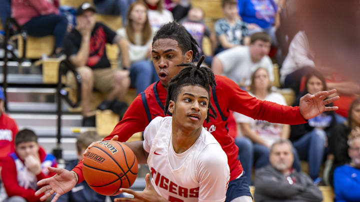 Fishers High School freshman Jason Gardner (5) drives the ball along the baseline while being defended by Kokomo High School sophomore Baris Moore (15) during the first half of a game in the Forum Tipoff Classic, Saturday, Dec. 9, 2023, at Southport High School.