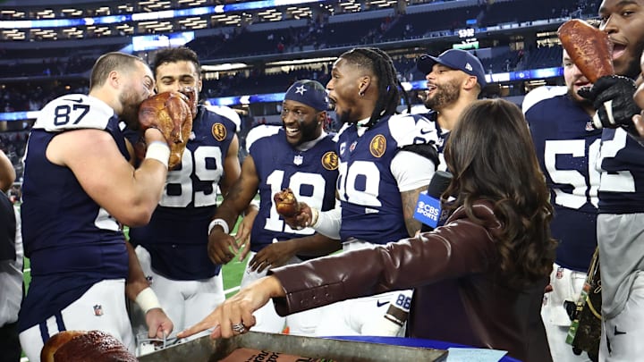 Dallas Cowboys TE Jake Ferguson and WR CeeDee Lamb celebrate with a turkey after the game against the Kansas City Chiefs.