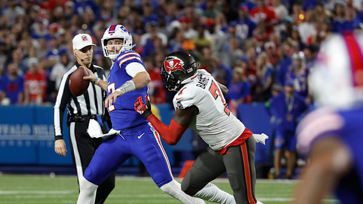 Buffalo Bills quarterback Josh Allen (17) looks downfield as he gets pressured by Tampa Bay Buccaneers linebacker Shaquil Barrett (7).