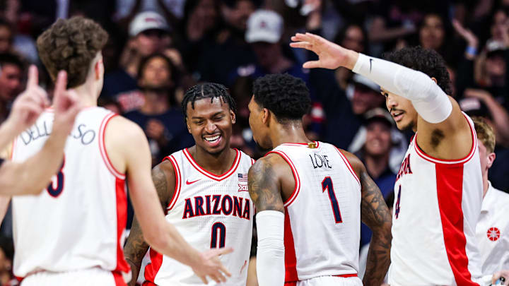 Feb 26, 2025; Tucson, Arizona, USA; Arizona Wildcats guard Jaden Bradley (0) celebrates with Arizona Wildcats guard Caleb Love (1) during the first half against the Utah Utes at McKale Center. Mandatory Credit: Aryanna Frank-Imagn Images