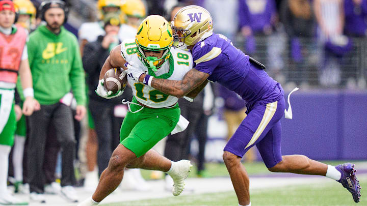 Oregon tight end Kenyon Sadiq carries the ball under cover from Washington cornerback Ephesians Prysock as the Oregon Ducks take on the Washington Huskies on Nov. 29, 2025, at Husky Stadium in Seattle, Washington. Oregon tight end Kenyon Sadiq carries the ball under cover from Washington cornerback Ephesians Prysock as the Oregon Ducks take on the Washington Huskies on Nov. 29, 2025, at Husky Stadium in Seattle, Washington.