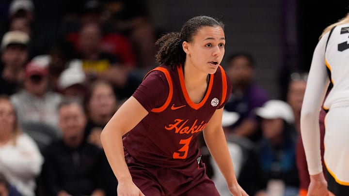 Nov 10, 2024; Charlotte, NC, USA; Virginia Tech Hokies guard Mackenzie Nelson (3) back on defense against Iowa Hawkeyes guard Lucy Olsen (33) during the second half at Spectrum Center. Mandatory Credit: Jim Dedmon-Imagn Images