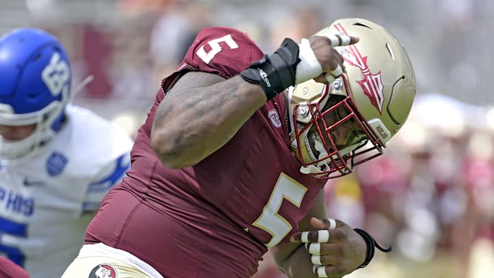 Sep 14, 2024; Tallahassee, Florida, USA; Florida State Seminoles defensive lineman Joshua Farmer (5) celebrates after a defensive stop against the Memphis Tigers during the first half at Doak S. Campbell Stadium. Mandatory Credit: Melina Myers-Imagn Images