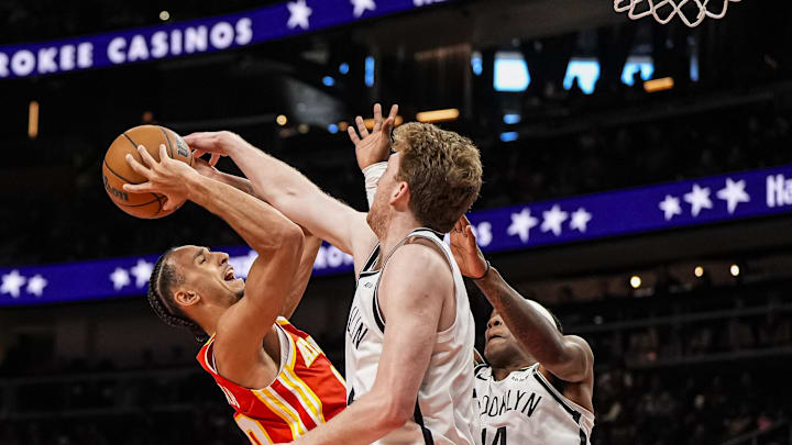 Feb 22, 2026; Atlanta, Georgia, USA; Atlanta Hawks forward Zaccharie Risacher (10) tries to shoot over Brooklyn Nets forward Danny Wolf (2) and guard Terance Mann (14) during the second half at State Farm Arena. Mandatory Credit: Dale Zanine-Imagn Images
