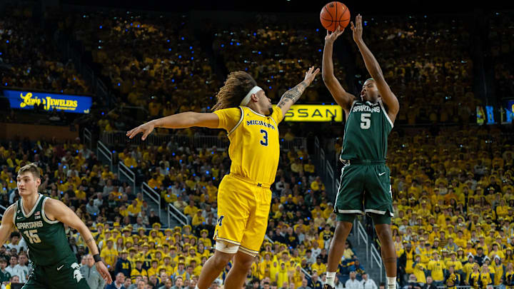 Michigan State’s Tre Holloman (5) shoots over Michigan’s Tre Donaldson (3) during the first half of their matchup at Crisler Center in Ann Arbor, on Friday, Feb. 21, 2025.