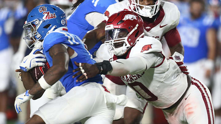 Sep 13, 2025; Oxford, Mississippi, USA; Mississippi Rebels running back Kewan Lacy (5) runs the ball as Arkansas Razorback defensive lineman Justus Boone (0) attempts to make the tackle during the third quarter at Vaught-Hemingway Stadium. Mandatory Credit: Petre Thomas-Imagn Images