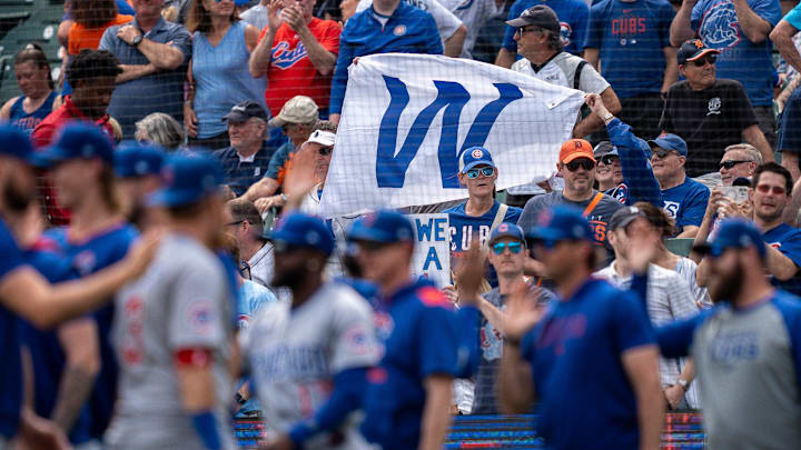 Fans hold a large “W” sign after the Chicago Cubs defeated the Detroit Tigers 6-1 at Comerica Park in Detroit on Saturday, June 7, 2025.