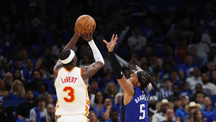 Apr 15, 2025; Orlando, Florida, USA; Atlanta Hawks guard Caris LeVert (3) shoots the ball over Orlando Magic forward Paolo Banchero (5) in the fourth quarter at Kia Center. Mandatory Credit: Nathan Ray Seebeck-Imagn Images