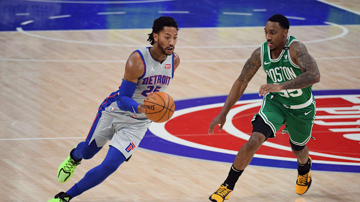 Jan 1, 2021; Detroit, Michigan, USA; Detroit Pistons guard Derrick Rose (25) drives past Boston Celtics guard Jeff Teague (55) during the first quarter at Little Caesars Arena. Mandatory Credit: Tim Fuller-Imagn Images