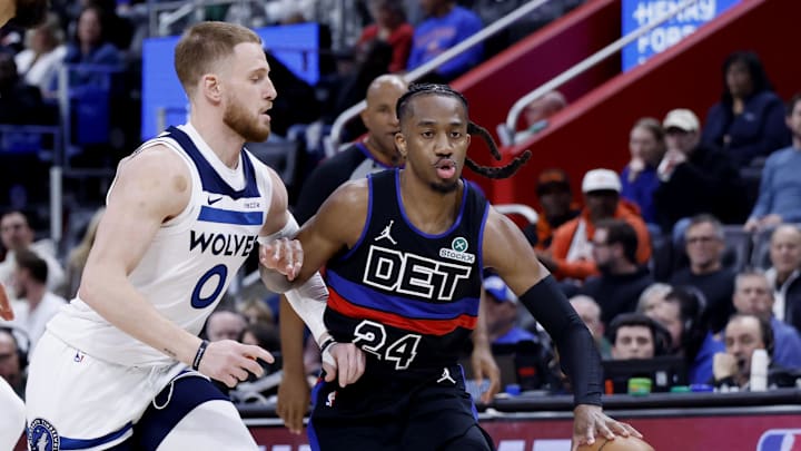 Apr 02, 2026; Detroit, Michigan, USA; Detroit Pistons guard Daniss Jenkins (24) dribbles the ball against Minnesota Timberwolves guard Donte DiVincenzo (0) in the first half at Little Caesars Arena. Mandatory Credit: Rick Osentoski-Imagn Images