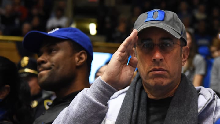 Comedian Jerry Seinfeld salutes during the second half at Cameron Indoor Stadium in 2019. 