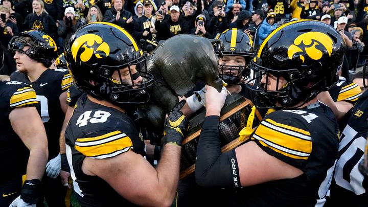 Iowa Hawkeyes defensive lineman Ethan Hurkett (49) helps carry the Floyd of Rosedale Trophy after the Hawkeyes defeated Minnesota Oct. 25, 2025 at Kinnick Stadium in Iowa City, Iowa. Iowa Hawkeyes defensive lineman Ethan Hurkett (49) helps carry the Floyd of Rosedale Trophy after the Hawkeyes defeated Minnesota Oct. 25, 2025 at Kinnick Stadium in Iowa City, Iowa.