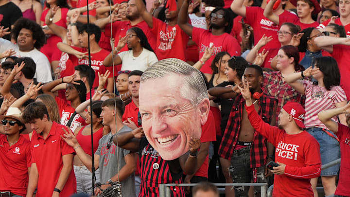 Houston Cougars fans hold up a sign of Houston football coach Willie Fritz at TDECU Stadium.