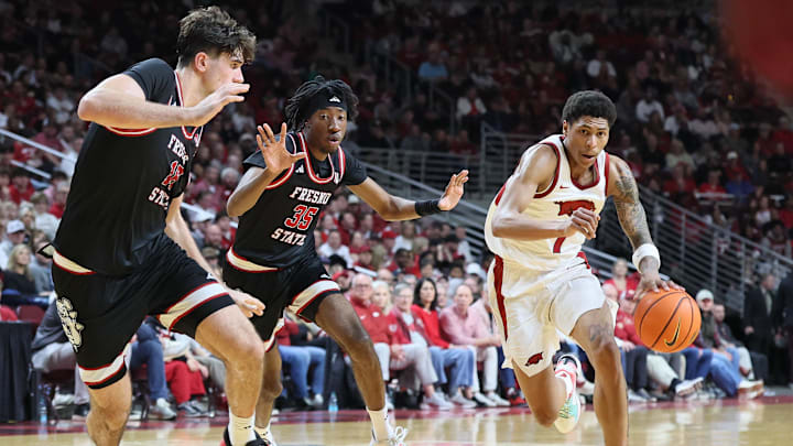 Dec 6, 2025; North Little Rock, Arkansas, USA; Arkansas Razorbacks guard Meleek Thomas (1) drives against Fresno State Bulldogs forwards Wilson Jacques (16) and DeShawn Gory (35) during the second half at Simmons Bank Arena. Arkansas won 82-58. Mandatory Credit: Nelson Chenault-Imagn Images Dec 6, 2025; North Little Rock, Arkansas, USA; Arkansas Razorbacks guard Meleek Thomas (1) drives against Fresno State Bulldogs forwards Wilson Jacques (16) and DeShawn Gory (35) during the second half at Simmons Bank Arena. Arkansas won 82-58. Mandatory Credit: Nelson Chenault-Imagn Images