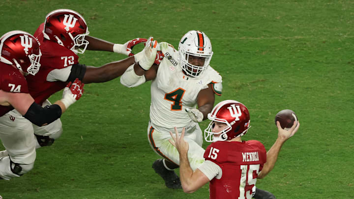 Jan 19, 2026; Miami Gardens, FL, USA; Indiana Hoosiers quarterback Fernando Mendoza (15) passes the ball under pressure by Miami Hurricanes defensive lineman Rueben Bain Jr. (4) in the third quarter during the College Football Playoff National Championship game at Hard Rock Stadium. Mandatory Credit: Kim Klement Neitzel-Imagn Images Jan 19, 2026; Miami Gardens, FL, USA; Indiana Hoosiers quarterback Fernando Mendoza (15) passes the ball under pressure by Miami Hurricanes defensive lineman Rueben Bain Jr. (4) in the third quarter during the College Football Playoff National Championship game at Hard Rock Stadium. Mandatory Credit: Kim Klement Neitzel-Imagn Images