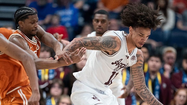 Texas Longhorns guard Tramon Mark (12) pressures Texas A&M Aggies forward Andersson Garcia (11) during their second round game of the SEC Men's Basketball Tournament at Bridgestone Arena in Nashville, Tenn., Thursday, March 13, 2025.
