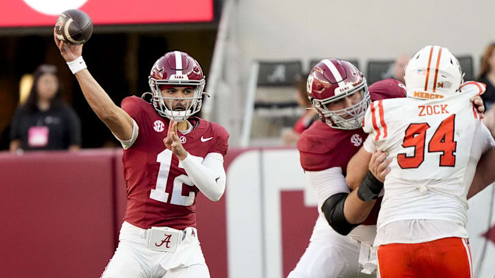 Nov 16, 2024; Tuscaloosa, AL, USA; Alabama Crimson Tide quarterback Dylan Lonergan (12) throws a pass offensive lineman Joseph Ionata (69) blocking on Mercer Bears defensive lineman Andrew Zock (94) at Bryant-Denny Stadium. Mandatory Credit: Gary Cosby Jr.-Imagn Images Nov 16, 2024; Tuscaloosa, AL, USA; Alabama Crimson Tide quarterback Dylan Lonergan (12) throws a pass offensive lineman Joseph Ionata (69) blocking on Mercer Bears defensive lineman Andrew Zock (94) at Bryant-Denny Stadium. Mandatory Credit: Gary Cosby Jr.-Imagn Images