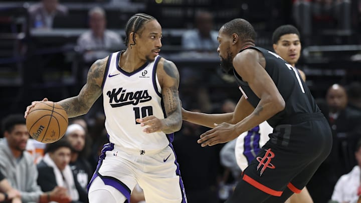 Feb 25, 2026; Houston, Texas, USA; Sacramento Kings guard DeMar DeRozan (10) controls the ball as Houston Rockets forward Kevin Durant (7) defends during the second quarter at Toyota Center. Mandatory Credit: Troy Taormina-Imagn Images